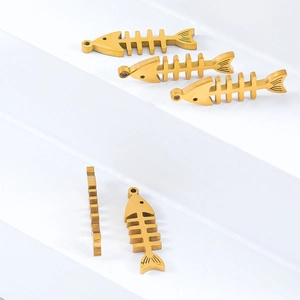 Detailed macro view of five golden fishbone pendants on a display stand showing thickness