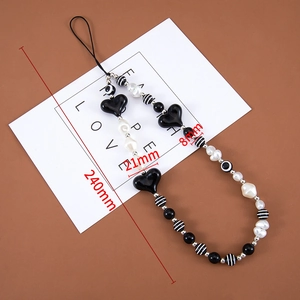 Detail view of black heart charm beaded phone strap with 240mm length measurements