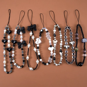 Y2K dark aesthetic beaded phone charms in black and white with bows and hearts