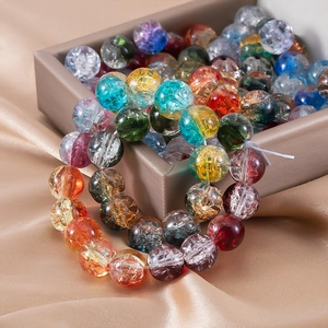 Macro shot of colorful 10mm cracked glass beads with ice flower texture on silk satin