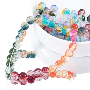 Macro shot of 10mm colorful cracked ice glass beads for DIY jewelry making in a white bowl