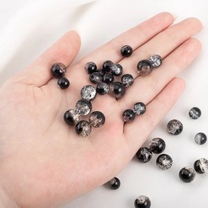 Detail view of 10mm black glass beads with silver foil ice crackle effect for jewelry