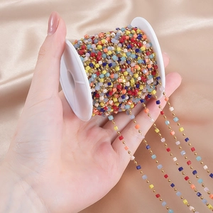 Detailed view of colorful beads on gold stainless steel chain on a plastic spool