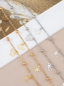 Close-up of gold and silver vintage butterfly tassel chains with hollow pendants