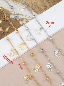 Detail of copper butterfly pendants with 2mm and 4mm beads in gold and silver finish