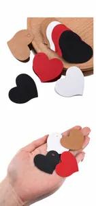 Macro view of heart-shaped kraft paper tags in multi-color options for DIY gift wrapping