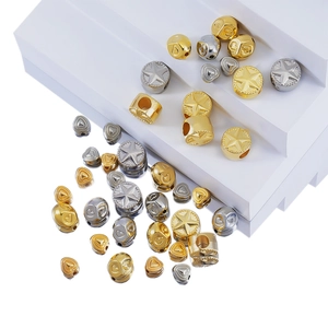 Macro detail of gold and silver heart and star shaped spacers for DIY jewelry making