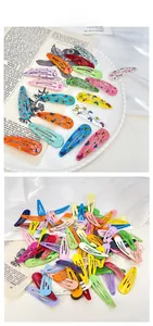 Detail view of assorted colorful patterned metal BB hair clips with floral and animal prints