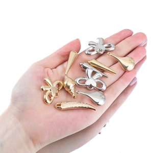 Assorted gold and silver DIY pendants featuring bow, water drop and shell shapes