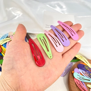 Macro detail of vibrant candy-colored metal hair clips in various bright matte finishes
