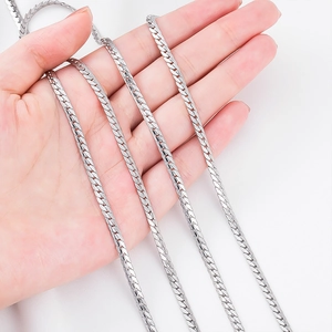 Close-up of polished silver stainless steel flat snake chain held in hand for jewelry making