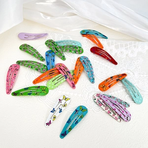 Close-up of colorful floral and butterfly printed metal BB hair clips on lace
