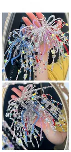 Macro detail of colorful acrylic beaded keychains with bow and cross charms on a handbag