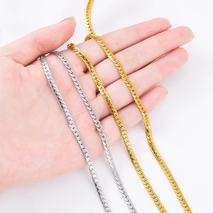 Gold and silver vacuum plated stainless steel flat snake chains held in hand for jewelry making