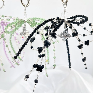 Close-up of handmade acrylic crystal beaded butterfly pendants in multiple colors