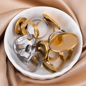 Close-up of gold and silver adjustable ring bases with blank trays for DIY jewelry making