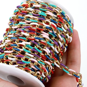 Macro shot of colorful enamel drips on golden stainless steel DIY link chain rolls