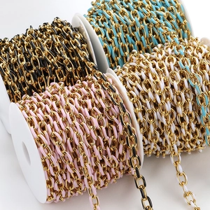 Macro detail of colorful enamel oil drip stainless steel link chains on white reels