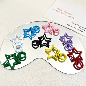 Detailed macro view of colorful star-shaped metal lobster clasps for DIY accessories