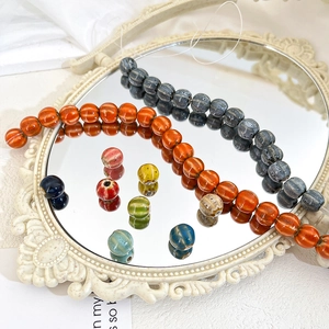 Macro detail of pumpkin shaped striped ceramic beads for DIY jewelry making