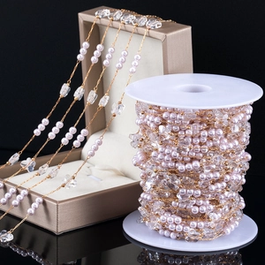 Detail of pink pearls and crystal beads on a gold chain reel for DIY jewelry making