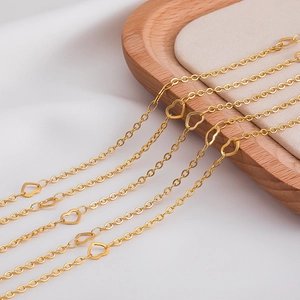 Detailed close-up of golden stainless steel heart-shaped links for DIY jewelry making