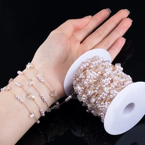 Detailed macro of pink pearls and crystal butterflies jewelry chain on a reel