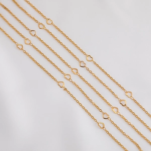 Macro view of golden heart-shaped stainless steel chain links for DIY jewelry making