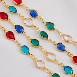 Detail of colorful teardrop glass stones on gold chain for DIY jewelry making