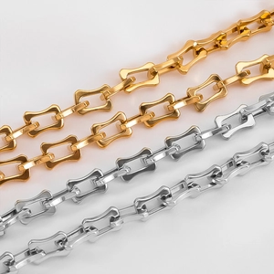Detailed macro of gold and silver bone-shaped rectangular stainless steel chain links