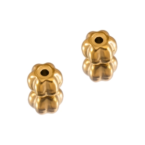Macro shot of two matte gold petal-shaped stainless steel spacer beads with reflections
