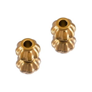 Macro shot of two golden stainless steel pumpkin beads for DIY jewelry making