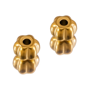 Detailed view of two golden pumpkin-shaped stainless steel beads for DIY jewelry making