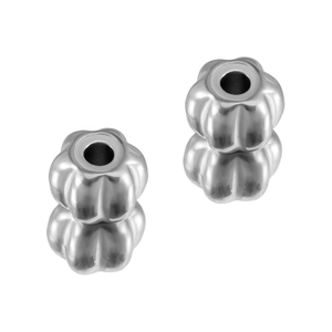 Macro detail of pumpkin shaped stainless steel beads with holes for DIY jewelry making