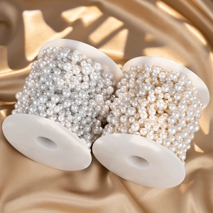 Detailed view of gold and silver DIY pearl bead chains on spools for jewelry making