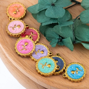 Macro detail of vintage rose charms in colorful enamel for DIY jewelry making