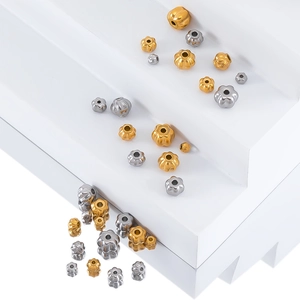 Macro shot of stainless steel pumpkin and petal shaped spacer beads for jewelry making