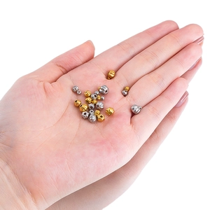 Macro detail of gold and silver stainless steel pumpkin beads for DIY jewelry making