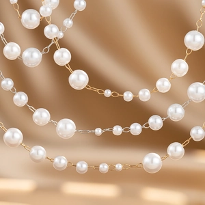 Macro detail of layered white pearl chain with gold and silver metal jewelry components