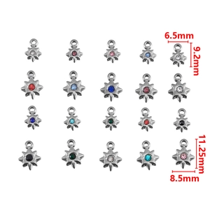 Detailed view of stainless steel star pendants with rhinestones in various colors for DIY
