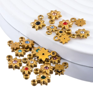 Detailed macro view of gold-plated eight-pointed star charms with colorful zircon stones