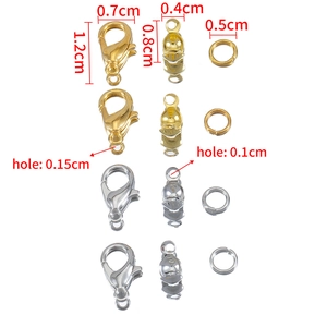 Detailed view of alloy lobster clasps and jump rings in gold and silver for DIY jewelry