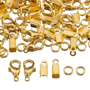 Close-up of golden lobster clasps, jump rings and ribbon ends for DIY jewelry making