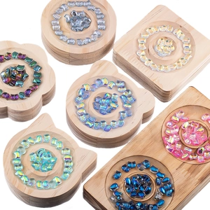 Colorful cat-shaped glass beads displayed in wooden trays for DIY jewelry making