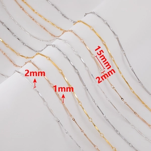 Detailed macro view of 1mm and 2mm copper chains with textured bars in gold and silver
