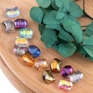 Macro detail of colorful cat-shaped glass beads for DIY jewelry with iridescent finish