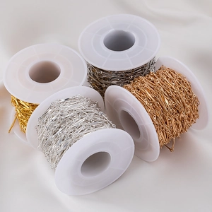 Detail view of DIY copper jewelry chains in gold and silver on plastic spools