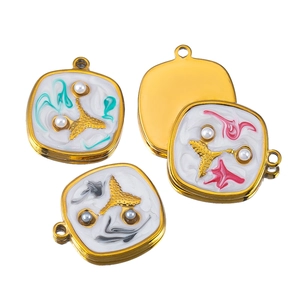 Detail of gold-plated starfish charms with colorful enamel and faux pearls for jewelry DIY