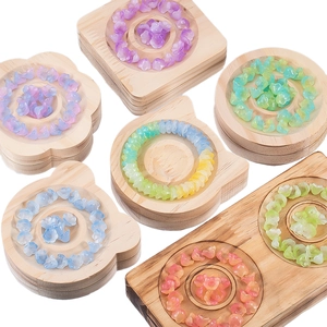 Macro detail of gradient lily of the valley glass beads in wooden display trays