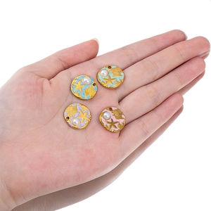 Detailed view of sea shell and starfish enamel charms in four soft pastel colors